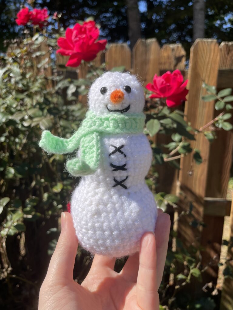 Crocheted Amigurumi Snowman Plush with a Green Scarf